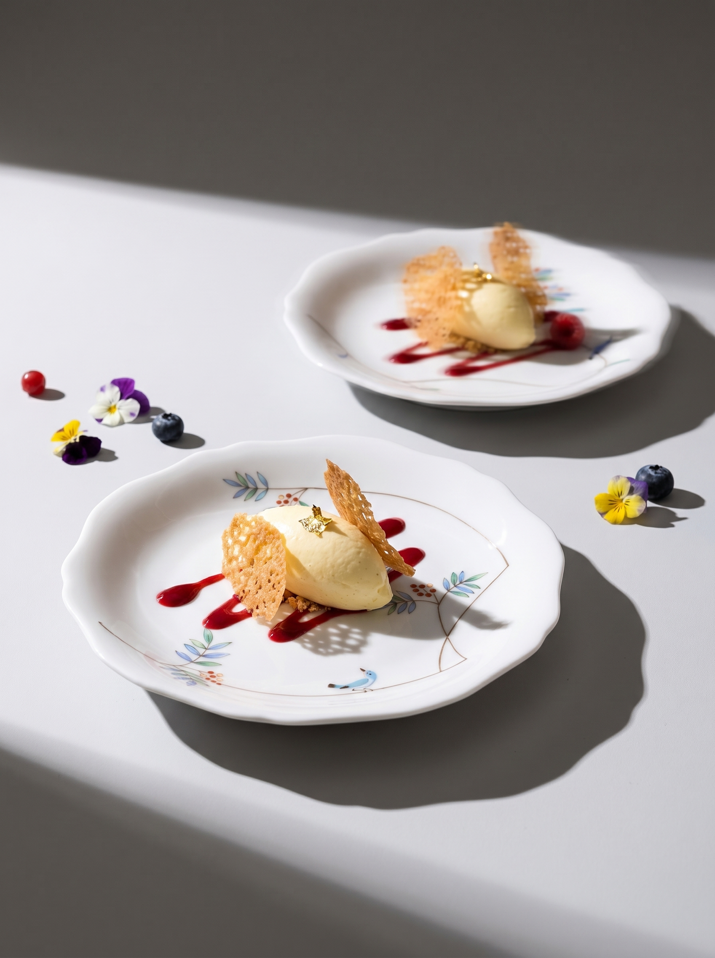 japanese porcelain dessert plates with restaurant style desserts on a grey background