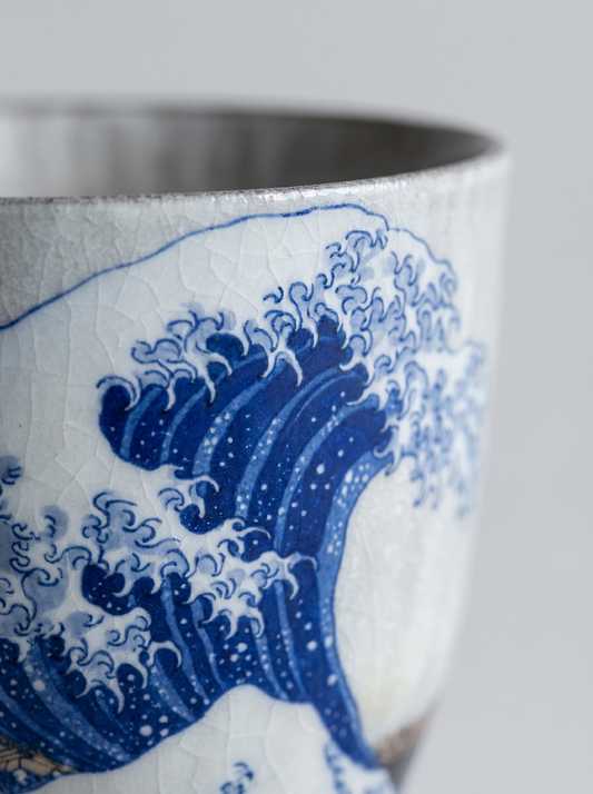 close up of Japanese kutani ceramic teacup with The Great Wave off Kanagawa design with no handle on a grey background