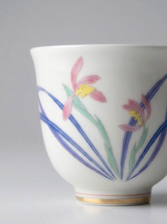 Close up of a porcelain cup with floral design on a gray background