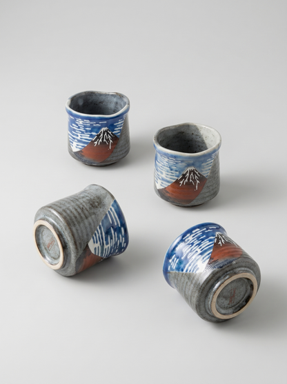 Four ceramic cups with Fuji mountain  design on a light gray background