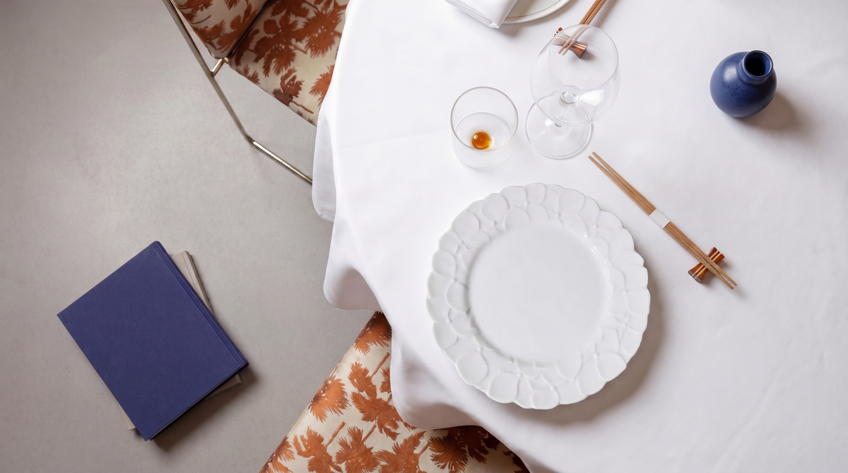 koransha porcelain embossed white plate surrounded by chopsticks