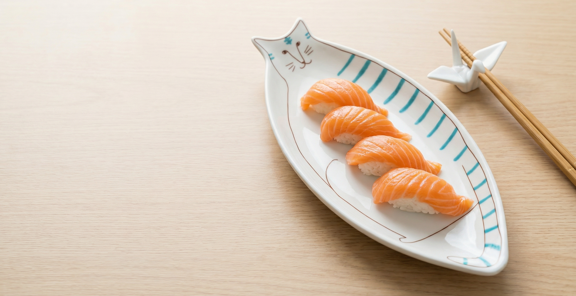 Sushi on a cat-shaped plate with chopsticks on a wooden surface