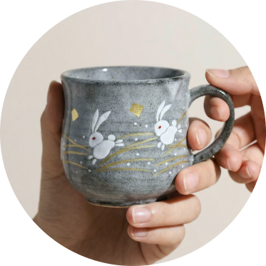 japanese ceramic teacup with a joyful hand-painted illustration