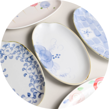 Set of Japanese ceramic plates with floral patterns on a white background