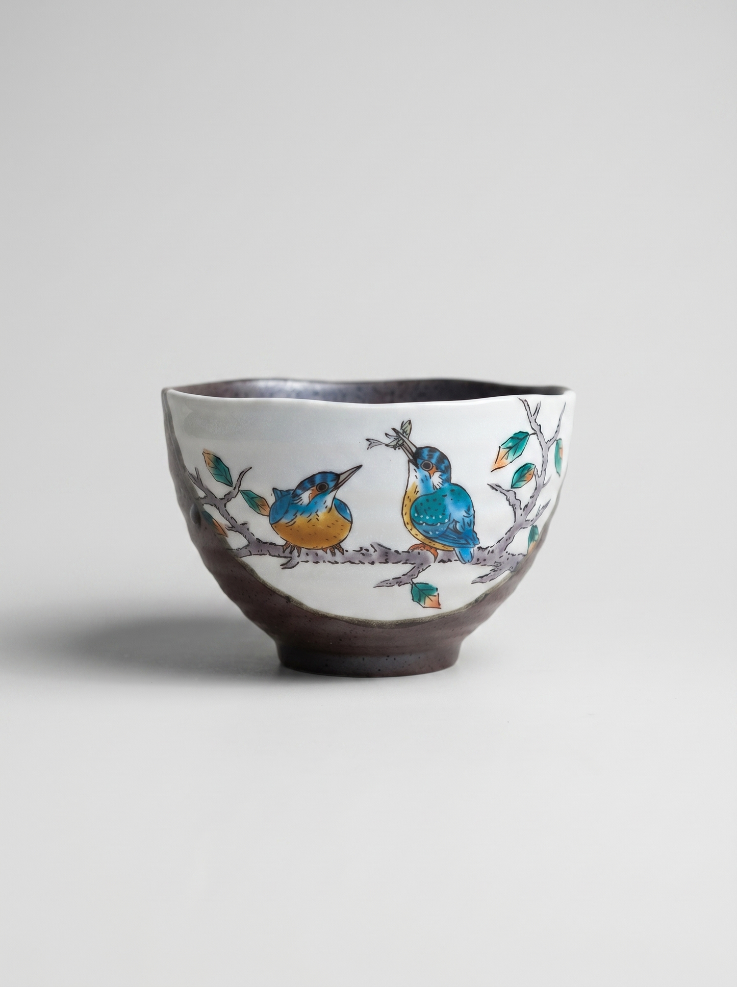 Japanese kutani ceramic small bowl with bird design on a light gray background