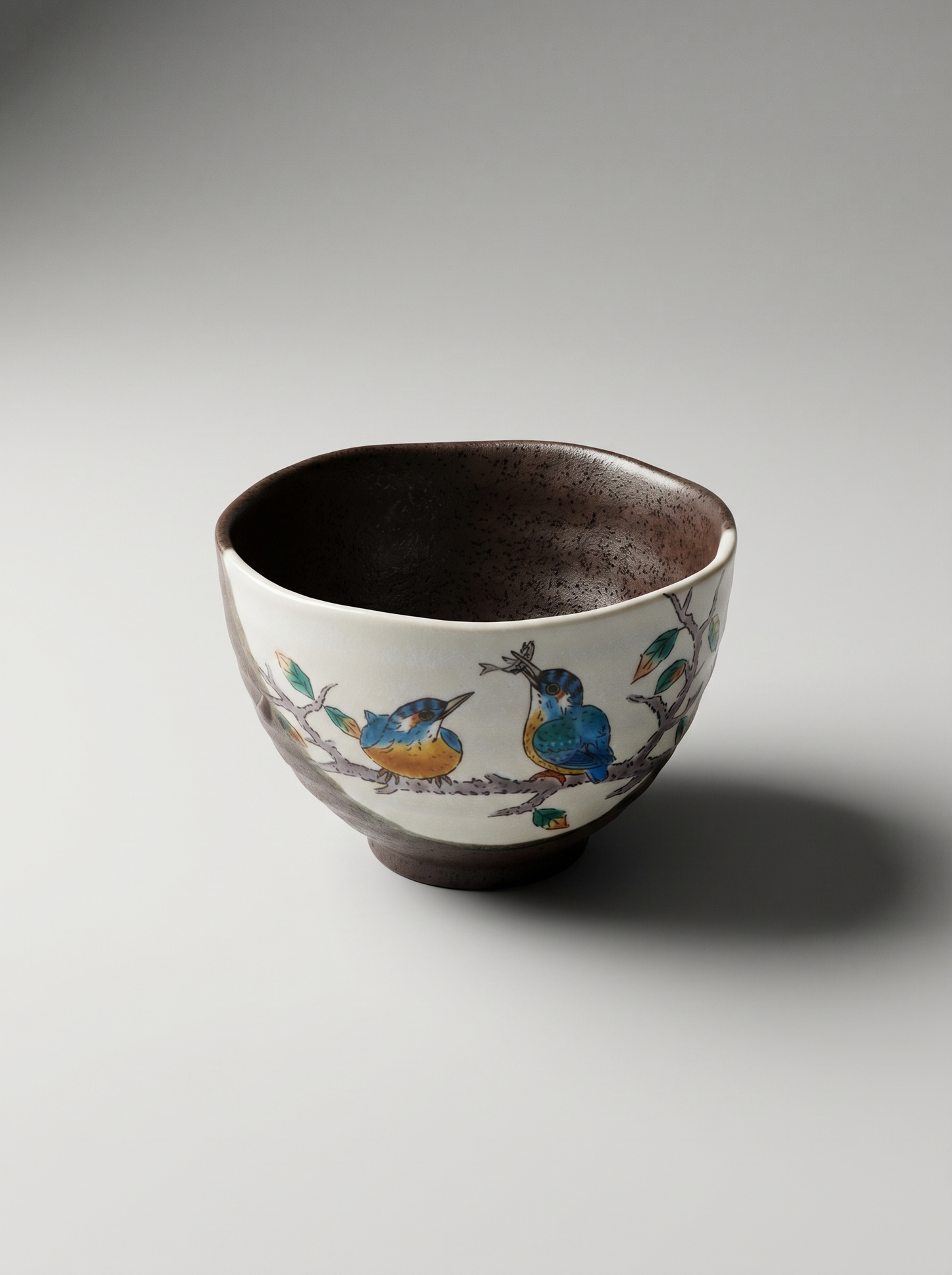 Ceramic bowl with bird design on a gray background
