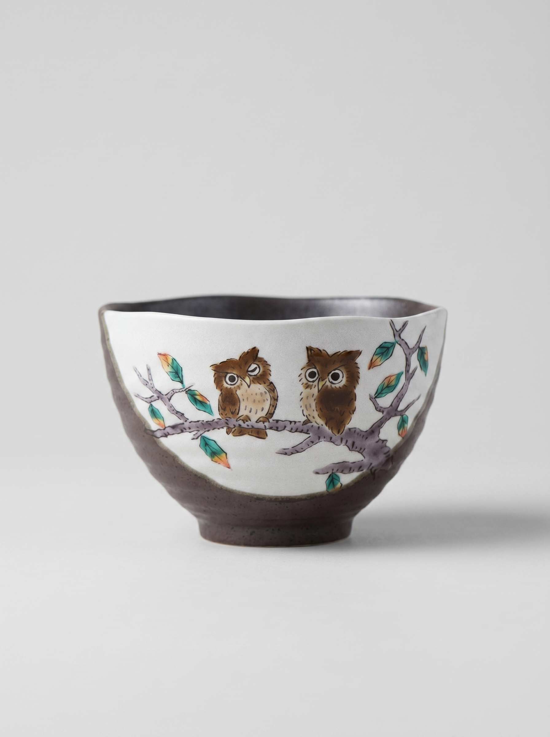 Japanese kutani ceramic bowl with owl design on a white background