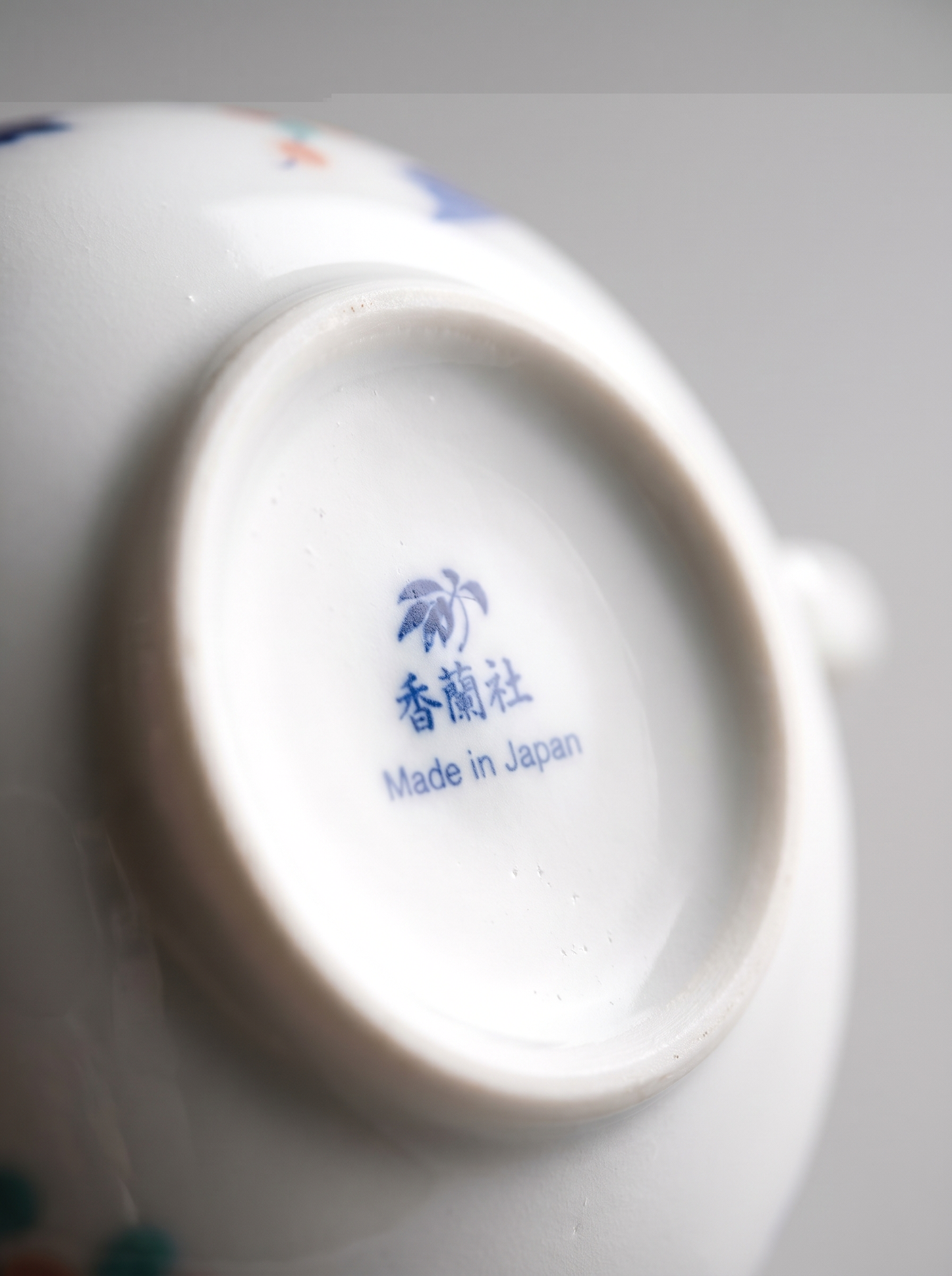 Close-up of a ceramic bowl with 'Made in Japan' text on a white background