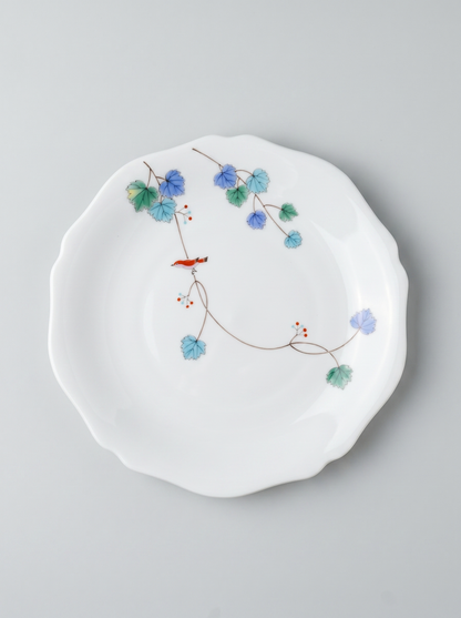 Japanese koransha porcelain dinner plate with floral design on a gray background