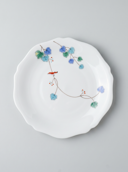Japanese koransha porcelain dinner plate with floral design on a gray background