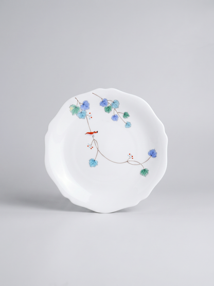 Japanese koransha porcelain dinner plate with floral design on a gray background
