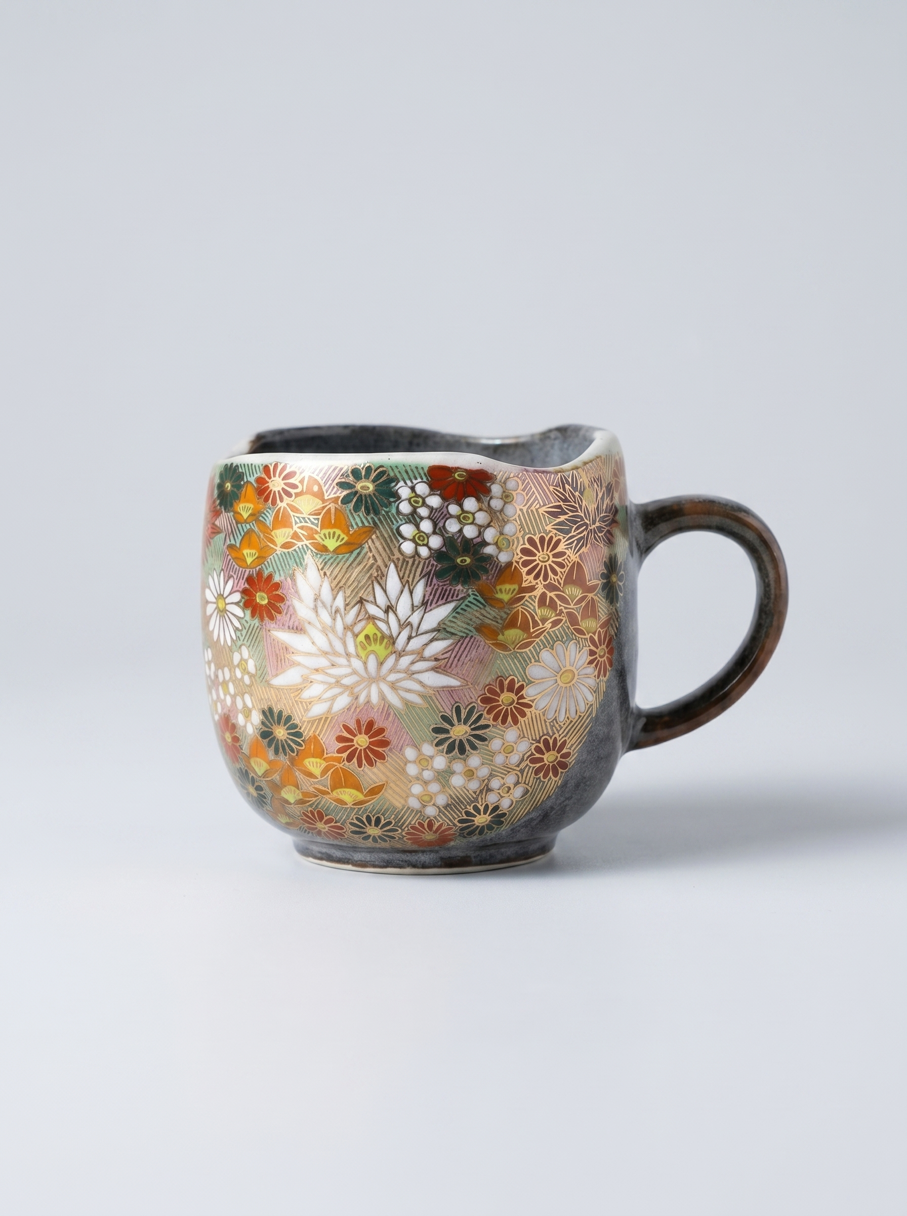 Japanese hanazume ceramic mug with floral pattern on a light gray background