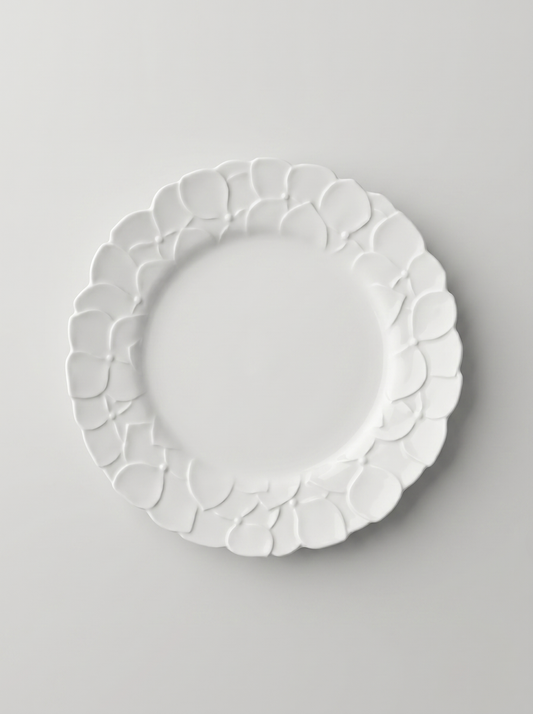 White Japanese koransha decorative plate with embossed surface on a light gray background