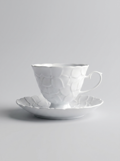 Japanese white koransha teacup with a short handle and a saucer on a sodt grey background