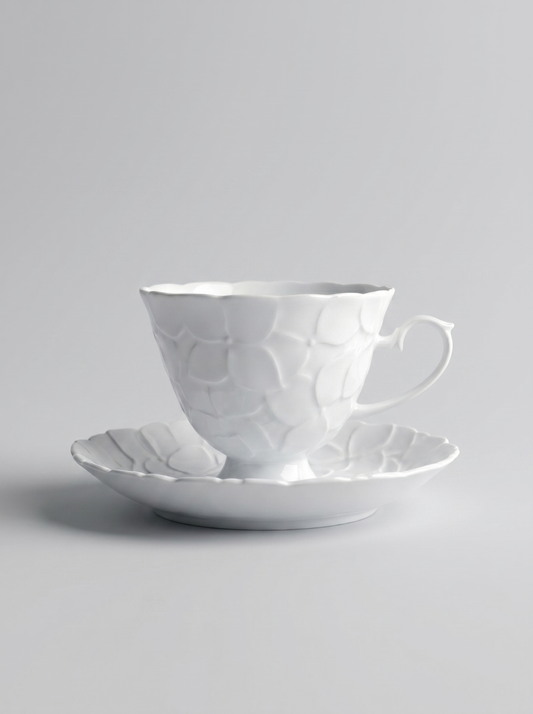 Japanese white koransha teacup with a short handle and a saucer on a sodt grey background