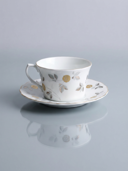 the reflection of a porcelain teacup with silver and gold accents