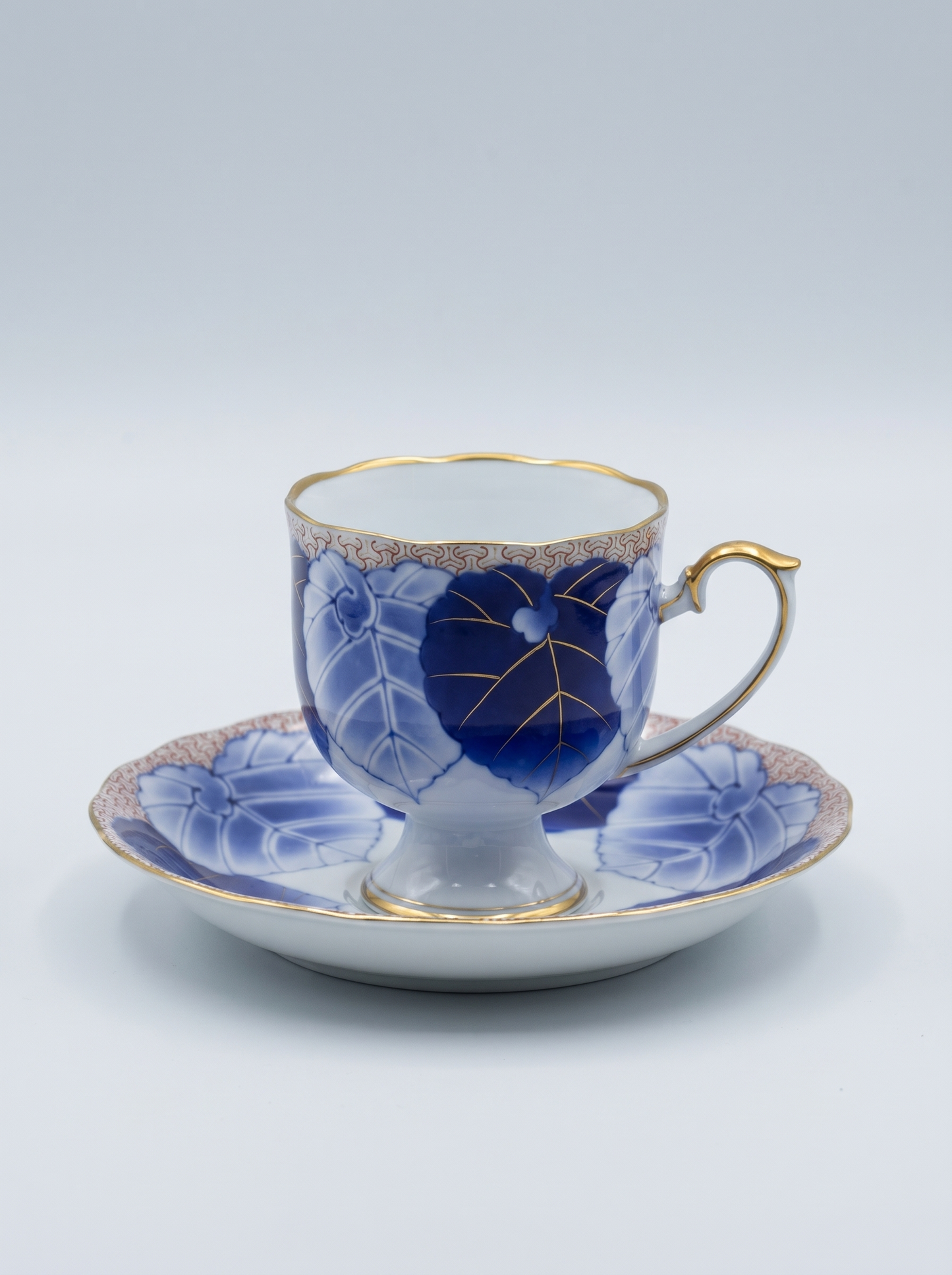 Japanese porcelain koransha tea cup and saucer with blue floral design on a white background