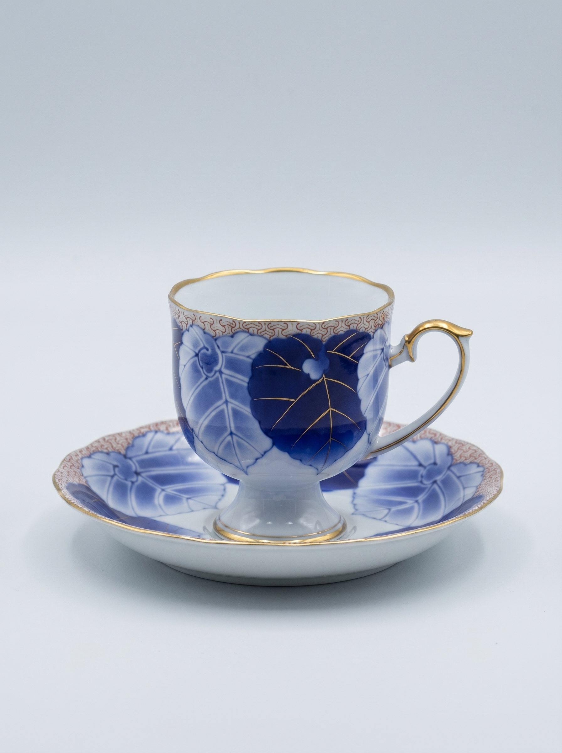 Japanese porcelain koransha tea cup and saucer with blue floral design on a white background