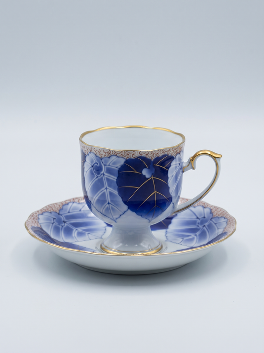 Japanese porcelain koransha tea cup and saucer with blue floral design on a white background