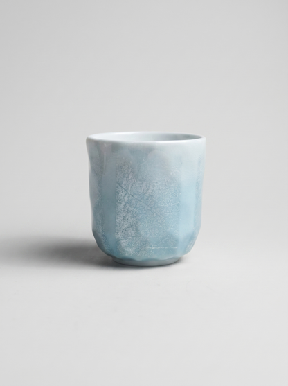 Japanese kutani light blue ceramic cup with ginsai finish on a gray background