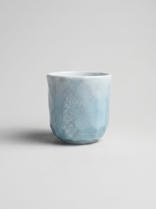 Japanese kutani light blue ceramic cup with ginsai finish on a gray background