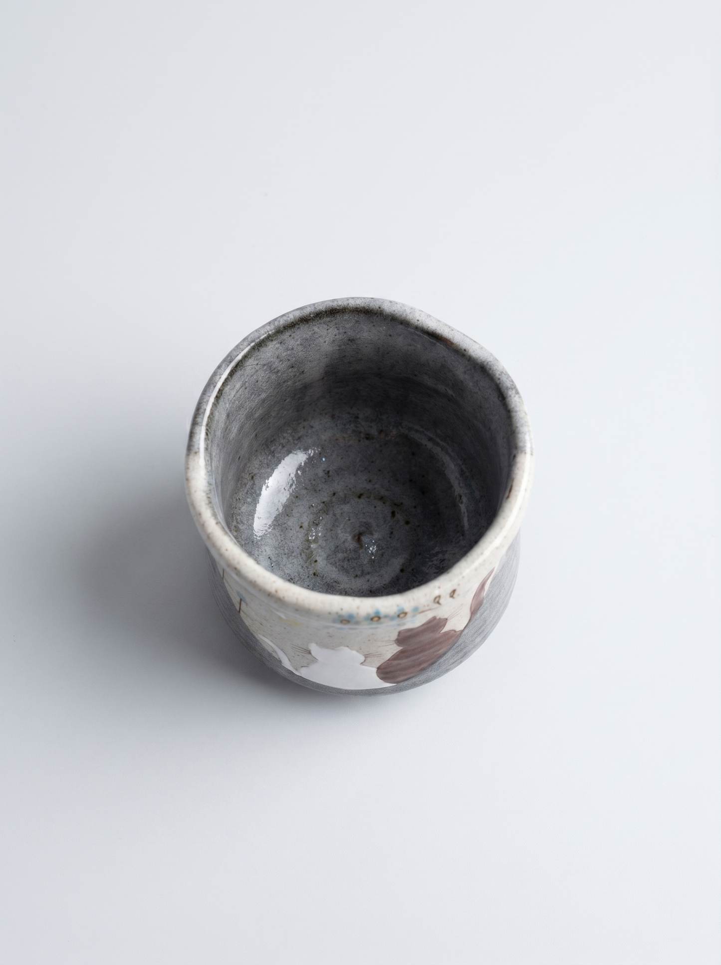 Small ceramic cup with a animal pattern on a white background top view