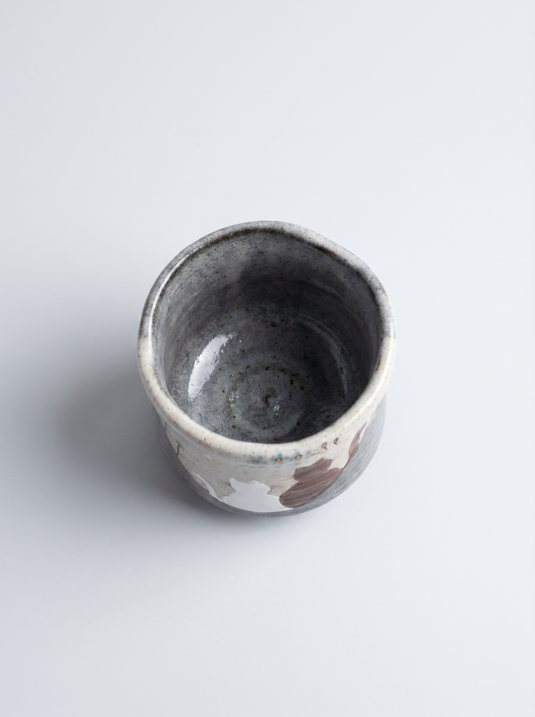 Small ceramic cup with a animal pattern on a white background top view