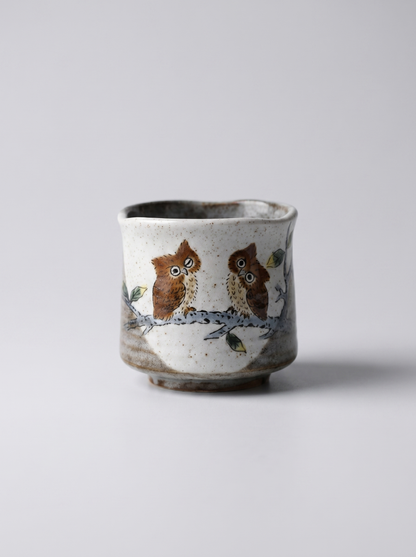 Japanese kutani ceramic cup with owl design on a light gray background