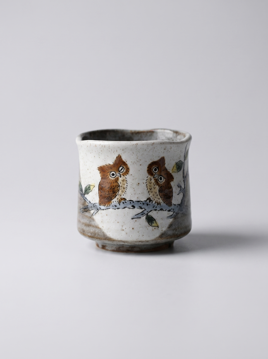 Japanese kutani ceramic cup with owl design on a light gray background