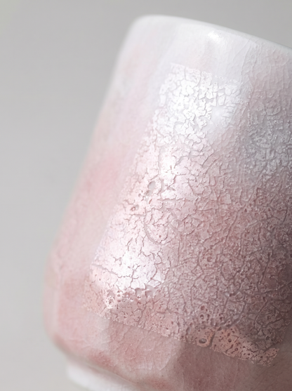 Close-up of a ginsai finish surface, pink teacup on a gray background