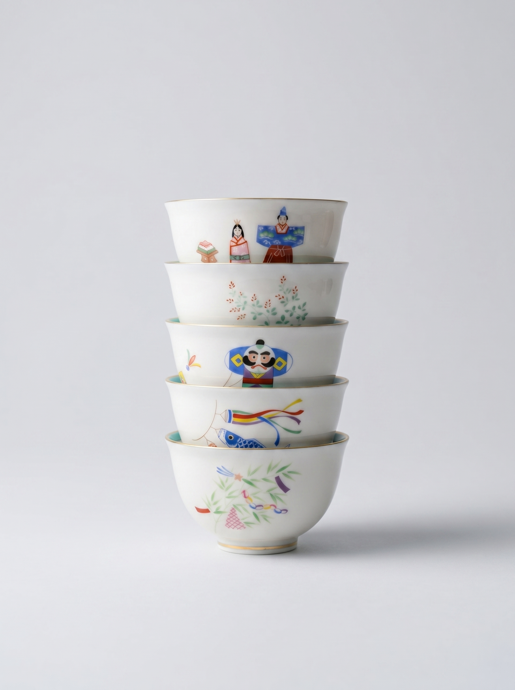 Set of Japanese koransha porcelain small teacups with no handle with colorful and joyful 'holidays' hand-painted designs on a light gray background