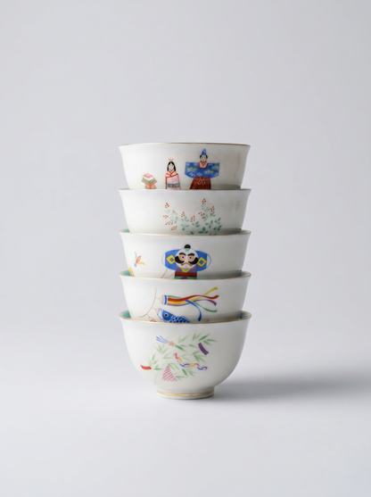 Set of Japanese koransha porcelain small teacups with no handle with colorful and joyful 'holidays' hand-painted designs on a light gray background