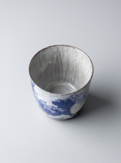 Japanese kutani ceramic teacup with The Great Wave off Kanagawa design with no handle on a grey background top view