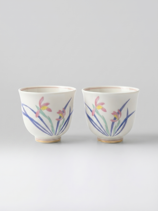 Two Japanese koransha porcelain teacups with floral designs on a light gray background