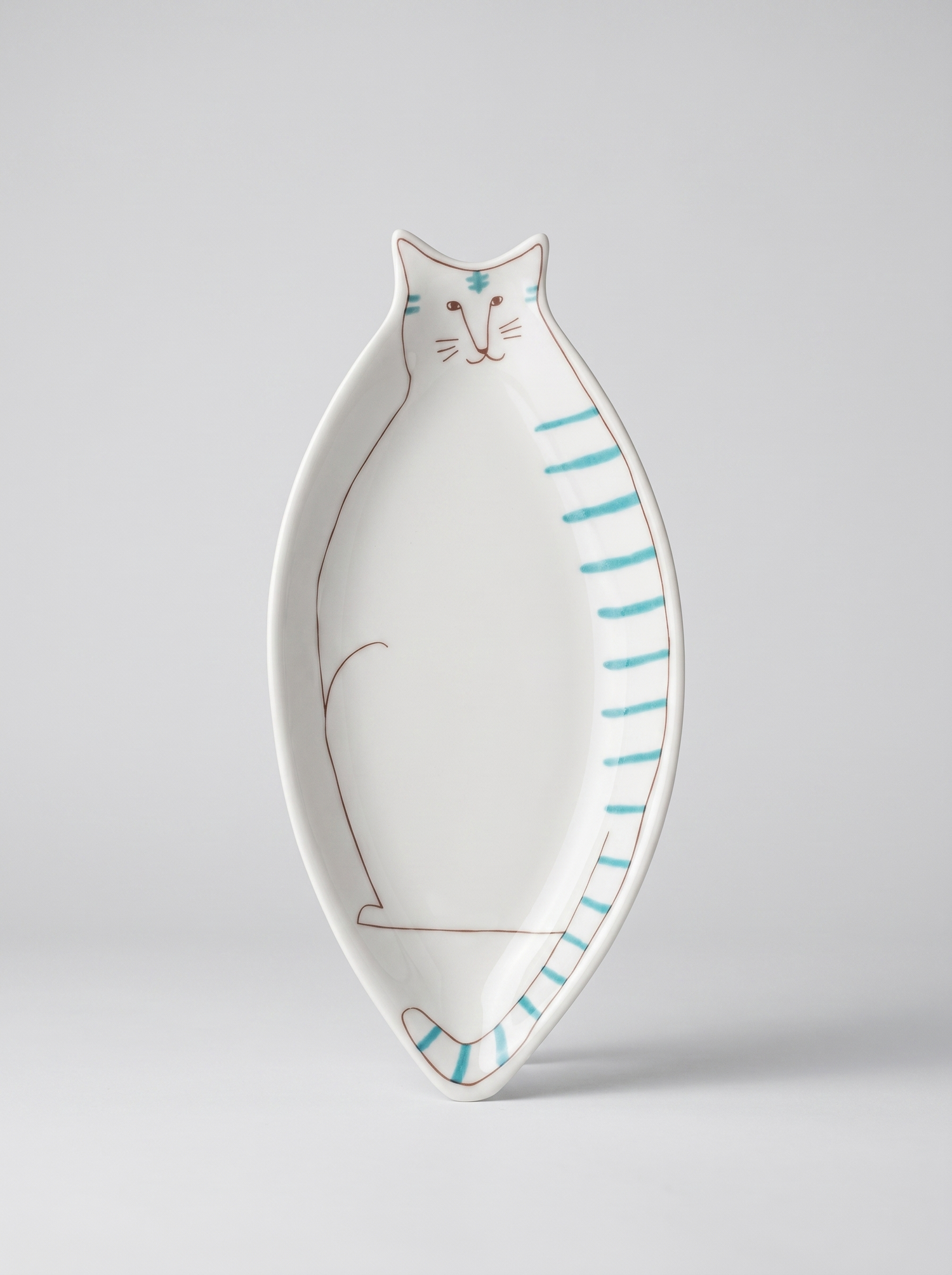 Cat-shaped ceramic plate with blue stripes on a light gray background