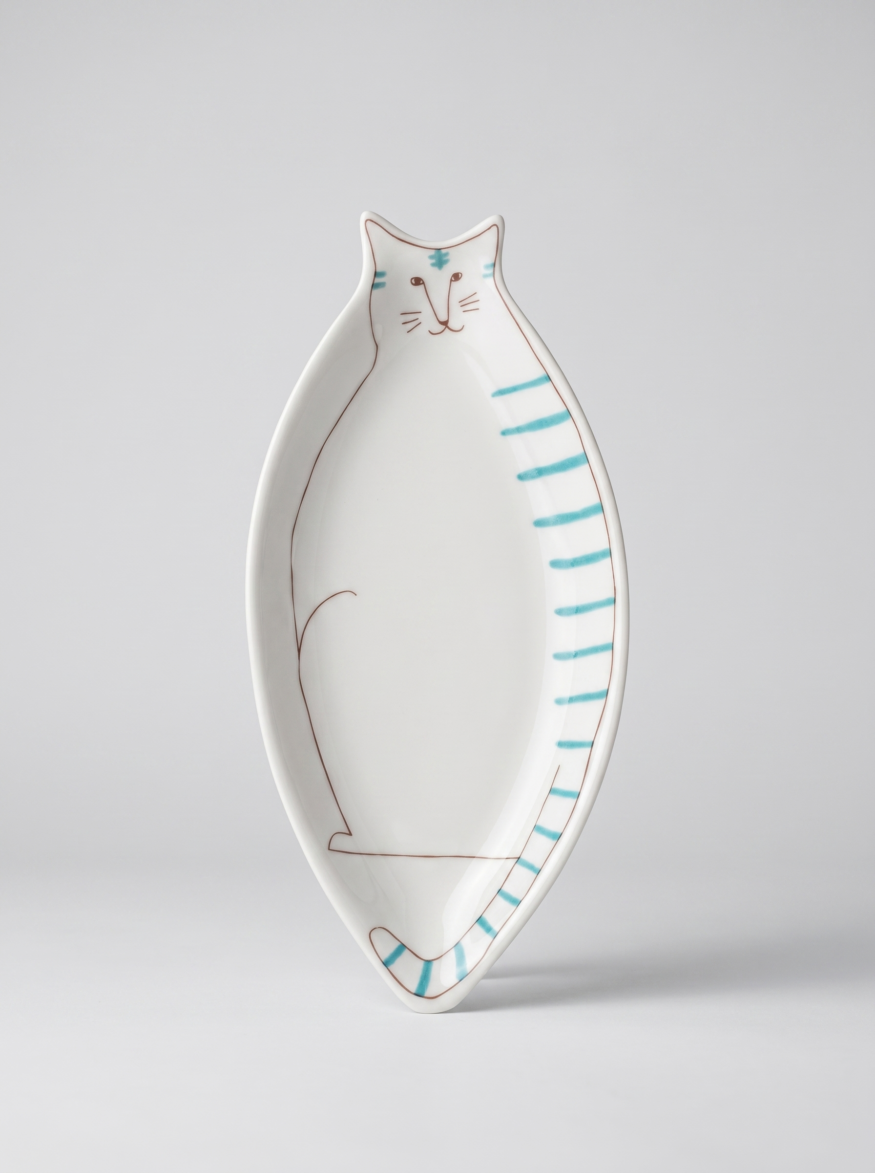 Cat-shaped ceramic plate with blue stripes on a light gray background