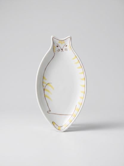 Cat-shaped ceramic plate with yellow accents on a light gray background