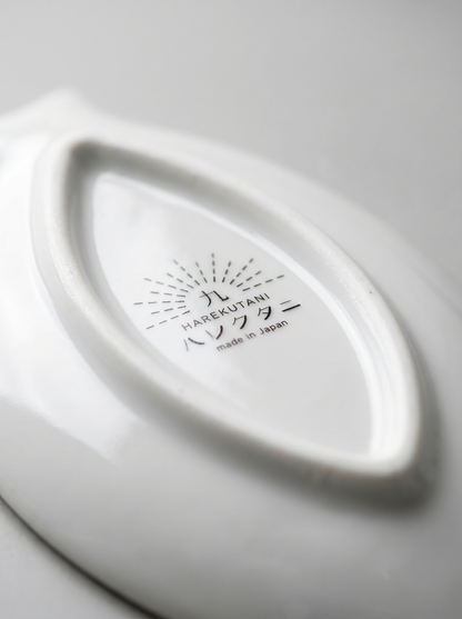 Close-up of a white ceramic product with 'Harekutani' branding on a light gray background