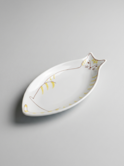Cat-shaped ceramic dish on a gray background
